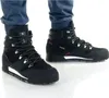 A pair of black Adidas Terrex Snowpitch C.rdy boots worn by a person. Voir les images du produit