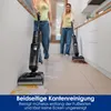 Two women are cleaning a floor with a Tineco wet dry vacuum cleaner in a modern kitchen and hallway setting. Podgląd zdjęcia produktu