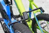 Close-up of two bicycles locked together with a black folding lock. Produktbild-Vorschau