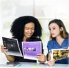 Two women are looking at documents and photos on a table. Produktbild-Vorschau