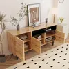 A wooden sideboard with open doors, displaying books and storage baskets, in a room with a patterned rug and a plant. Anteprima dell’immagine prodotto