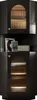 A black corner cabinet with fluted glass doors, displaying records, a book, and a speaker on its shelves. Produktbild-Vorschau