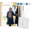 A woman is opening a door, and a smart home device is shown in the foreground. Produktbild-Vorschau