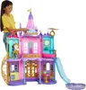 A young girl is playing with a large, multi-story toy castle. Podgląd zdjęcia produktu