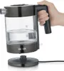 A hand is holding a glass electric kettle filled with water. Podgląd zdjęcia produktu