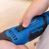 A close-up shot of a person's hand operating a blue and black power tool. Produktbild-Vorschau