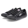 A pair of black low-top sneakers on a white background. Produktbild-Vorschau