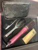 A hairdryer and accessories laid out in a box. Produktbild-Vorschau