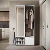 A modern entryway with a white wardrobe unit featuring a mirror, coat rack, shoe storage, and a drawer. An umbrella is leaning against the side. Anteprima dell’immagine prodotto