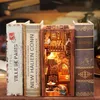 A DIY book nook kit designed to look like a miniature atmospheric bookstore, placed between two decorative book spines. Voir les images du produit