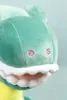 Close-up of a stuffed dinosaur toy's head. Produktbild-Vorschau