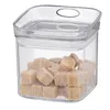 A clear plastic food storage container filled with brown sugar cubes. Voir les images du produit