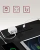 A close-up shot of a black power strip integrated into a wooden surface, with a white power adapter and charging cables connected to a smartphone and tablet. Náhled obrázku produktu