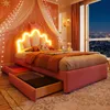 A child's bedroom with a pink princess-themed bed, decorated with fairy lights and a crown-shaped headboard with neon lighting. The room overlooks a city skyline at night. Produktbild-Vorschau