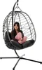 A woman sits in a hanging egg chair. Produktbild-Vorschau