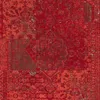 A close-up, full-frame view of a red rug with a distressed, vintage-inspired pattern. Produktbild-Vorschau