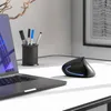 A black ergonomic mouse sits on a white desk next to a laptop. Produktbild-Vorschau