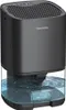 A black dehumidifier with a clear water tank filled with blue water sits on a white background. Náhled obrázku produktu