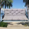 A light gray tufted bench cushion is shown hanging from chains, suspended between two palm trees with a beach and ocean scene in the background. Voir les images du produit