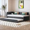 A daybed with an extended trundle bed is shown in a room with a plant and artwork on the wall. Produktbild-Vorschau