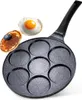 A multi-cup frying pan with a pancake and a fried egg on a white background. Produktbild-Vorschau