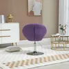 A purple armchair is placed on a rug in a room with a dresser and a coffee table. Produktbild-Vorschau