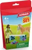 A toy playset featuring a girl and a horse on a grassy field with a blue bench and accessories. Produktbild-Vorschau