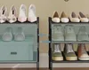 Two adjacent shoe racks, each with three shelves, displaying various types of shoes. Náhled obrázku produktu