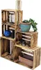 A display of wooden crates stacked in a staggered arrangement, showcasing decorative items within them. Anteprima dell’immagine prodotto