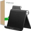 A black phone stand is shown in front of its packaging. Voir les images du produit