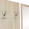 A close-up view of a wooden wall panel with two metal coat hooks attached. Náhled obrázku produktu