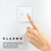 A hand is shown pressing a touch-sensitive light switch on a white wall. Podgląd zdjęcia produktu