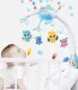 A baby looking up at a mobile hanging over a crib. Náhľad obrázku produktu