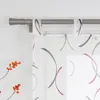A close-up view of a window with sheer curtains hanging from a curtain rod. Produktbild-Vorschau