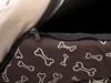 A close-up view of a zipper on a dog bed with a bone pattern. Produktbild-Vorschau