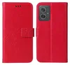 A red flip phone case with floral and butterfly embossing is shown open, displaying the inside and the exterior. Produktbild-Vorschau