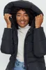 A woman wearing a black puffer coat and a cream turtleneck. Produktbild-Vorschau