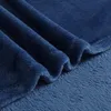 A close-up view of a folded dark blue blanket. Produktbild-Vorschau