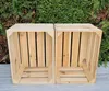 Two wooden crates are placed side-by-side in front of a green hedge. Produktbild-Vorschau