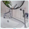 A close-up view of a bidet hand shower attached to a sink faucet, with a mirror reflecting a plant and the faucet. Anteprima dell’immagine prodotto