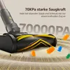 A close-up of a vacuum cleaner head on a carpet, with gummy bear-like objects being sucked up. Produktbild-Vorschau