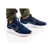 A pair of blue Nike Downshifter 12 men's shoes worn by a person. Anteprima dell’immagine prodotto