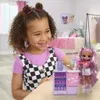 A young girl is playing with a doll and a toy cafe set in a room. Podgląd zdjęcia produktu