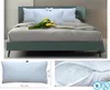 A bed with pillows and a bouquet of tulips, and close-up views of a pillow. Produktbild-Vorschau