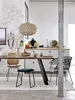 A dining area with a wooden table, chairs, and a kitchen counter in the background. Produktbild-Vorschau