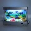 A small, decorative LED aquarium with artificial fish and plants, illuminated from within. Náhľad obrázku produktu
