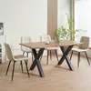 A dining set with a wooden table and four beige upholstered chairs in a well-lit room. Produktbild-Vorschau