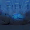 A plush toy with a glowing blue projector on its head, projecting light beams upwards. Produktbild-Vorschau