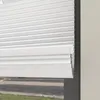 A close-up view of white pleated blinds partially covering a window. Produktbild-Vorschau
