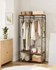 A clothing rack with clothes and storage shelves, placed in a room with a dresser and a plant. Produktbild-Vorschau